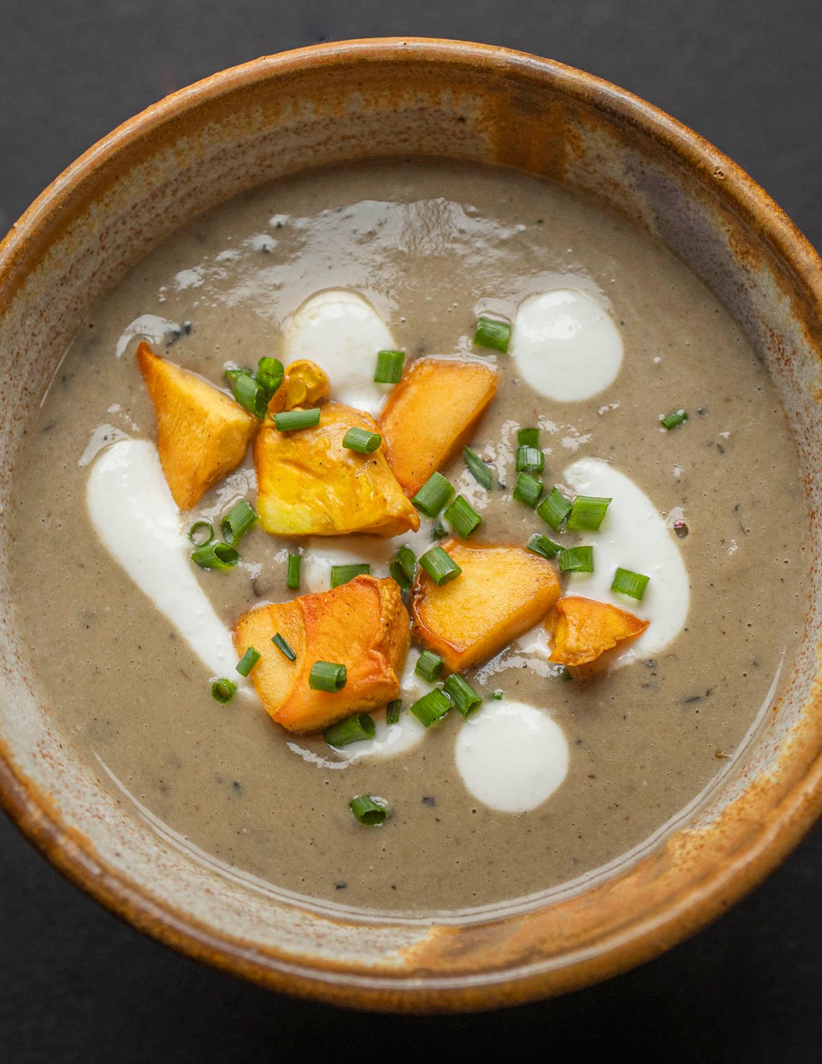 A bowl of mushroom soup with chicken of the woods and creme fraiche. 