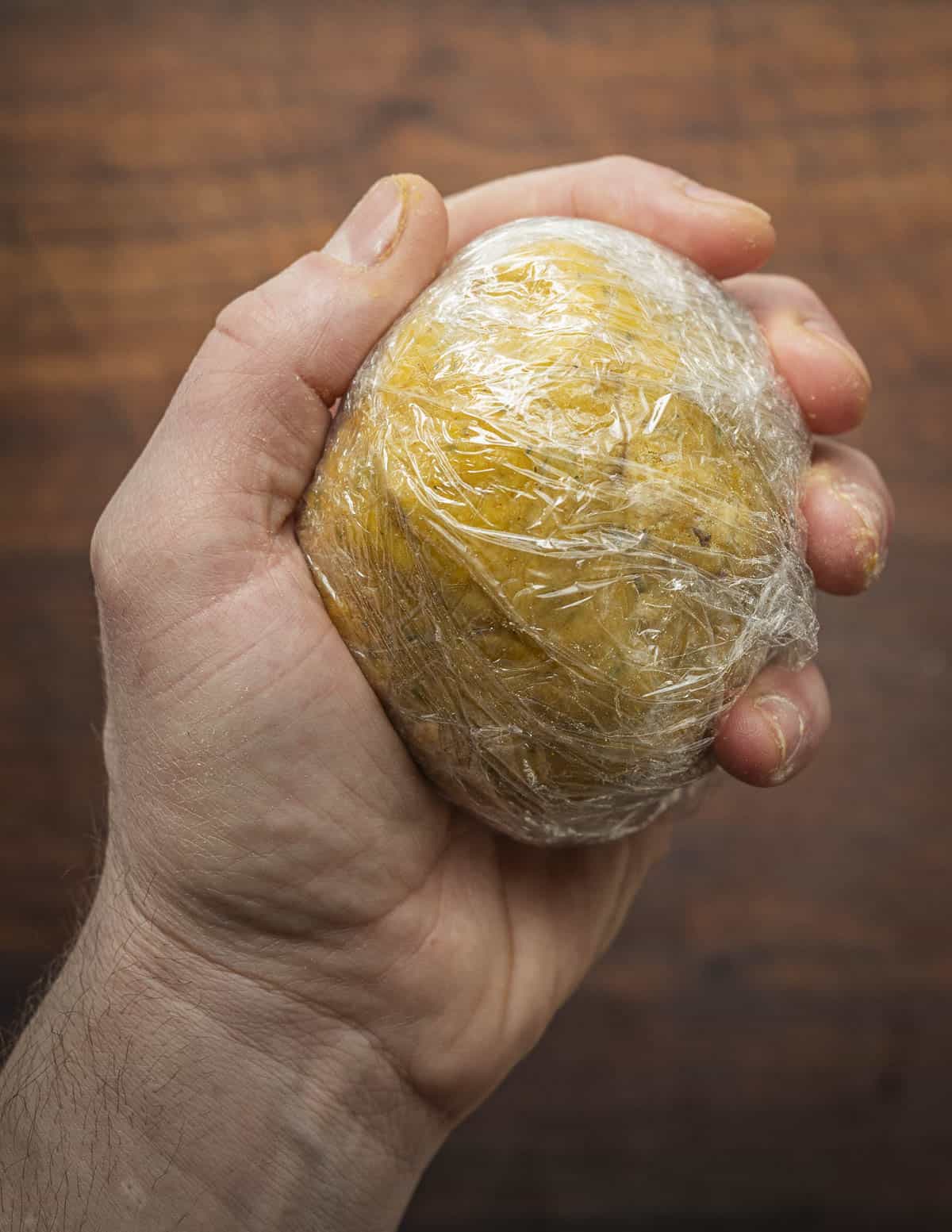 Wrapping chickpea or garbonzo bean flour flatbread dough in cling film. 