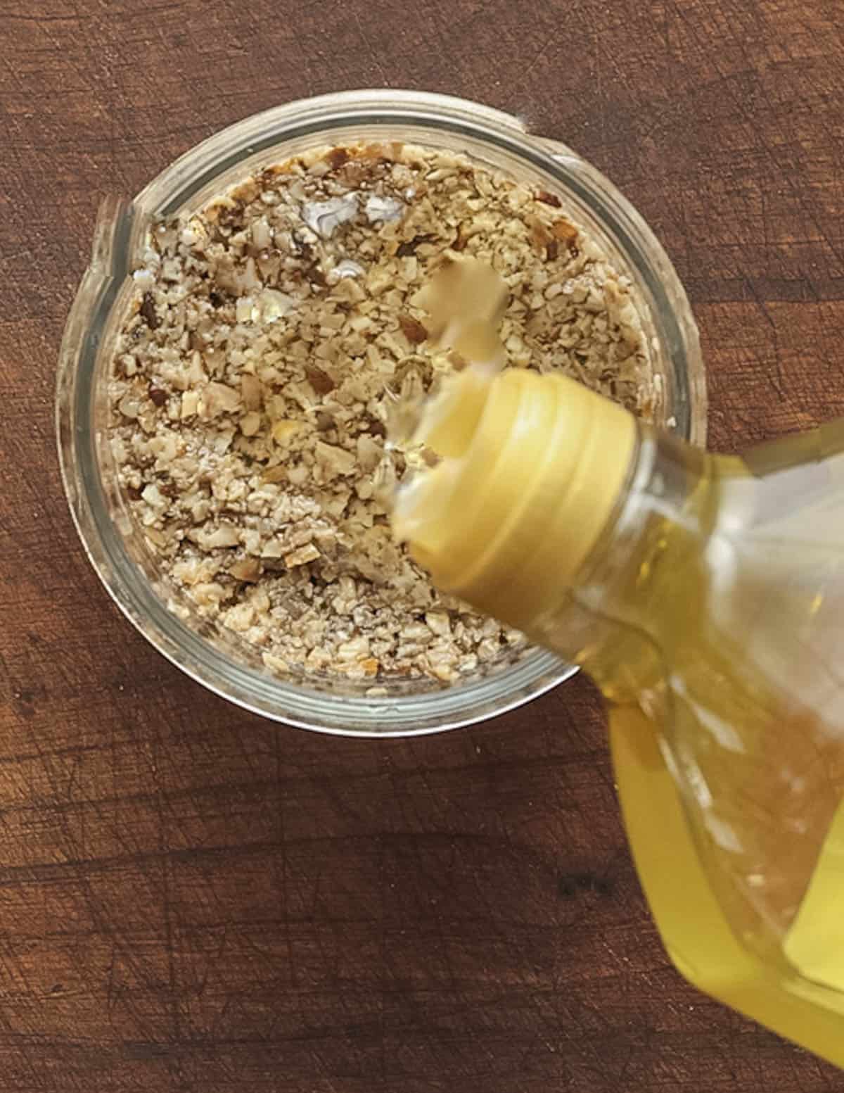 Topping a jar off mushroom tartufata off with a drizzle of grapeseed oil. 