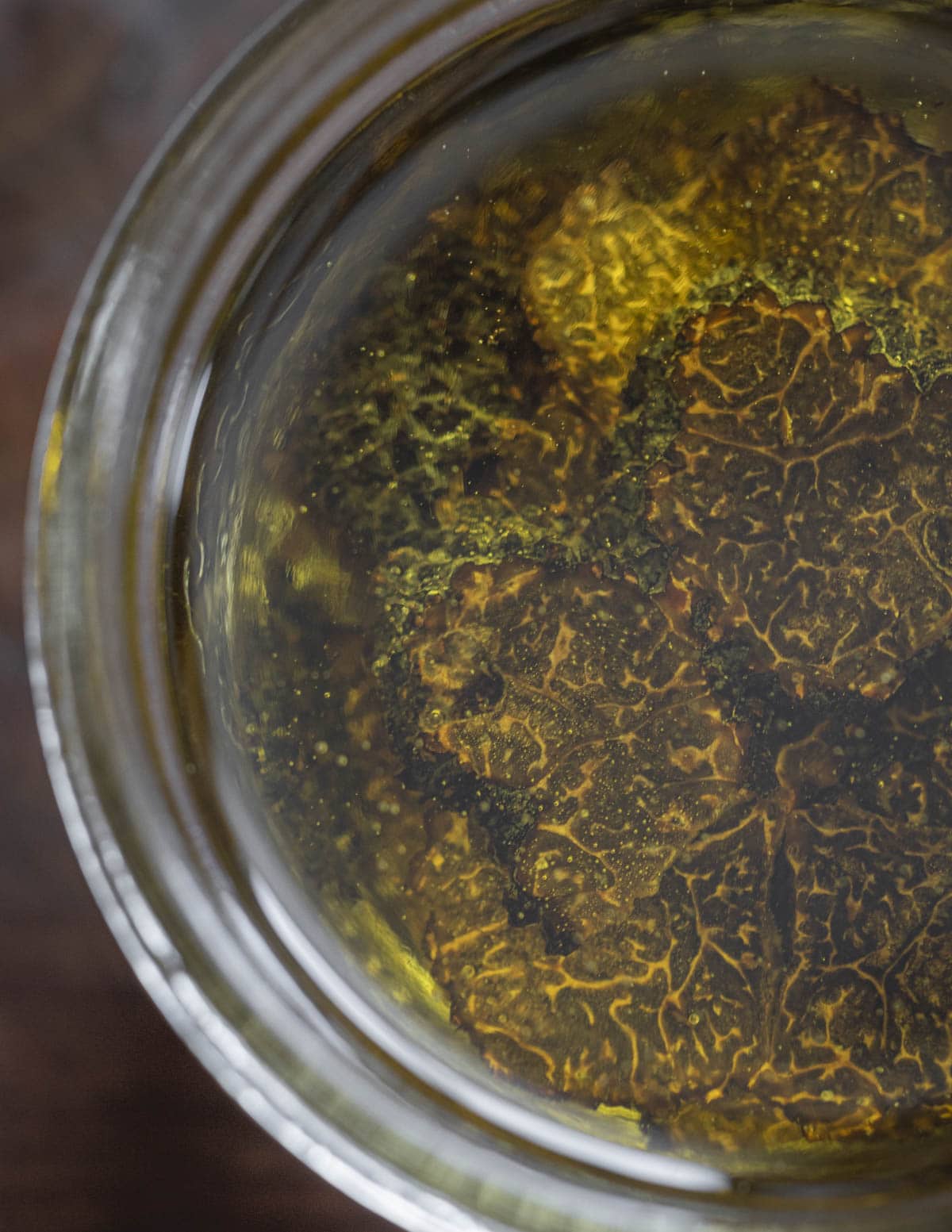 Slices of black truffle in oil in a mason jar. 