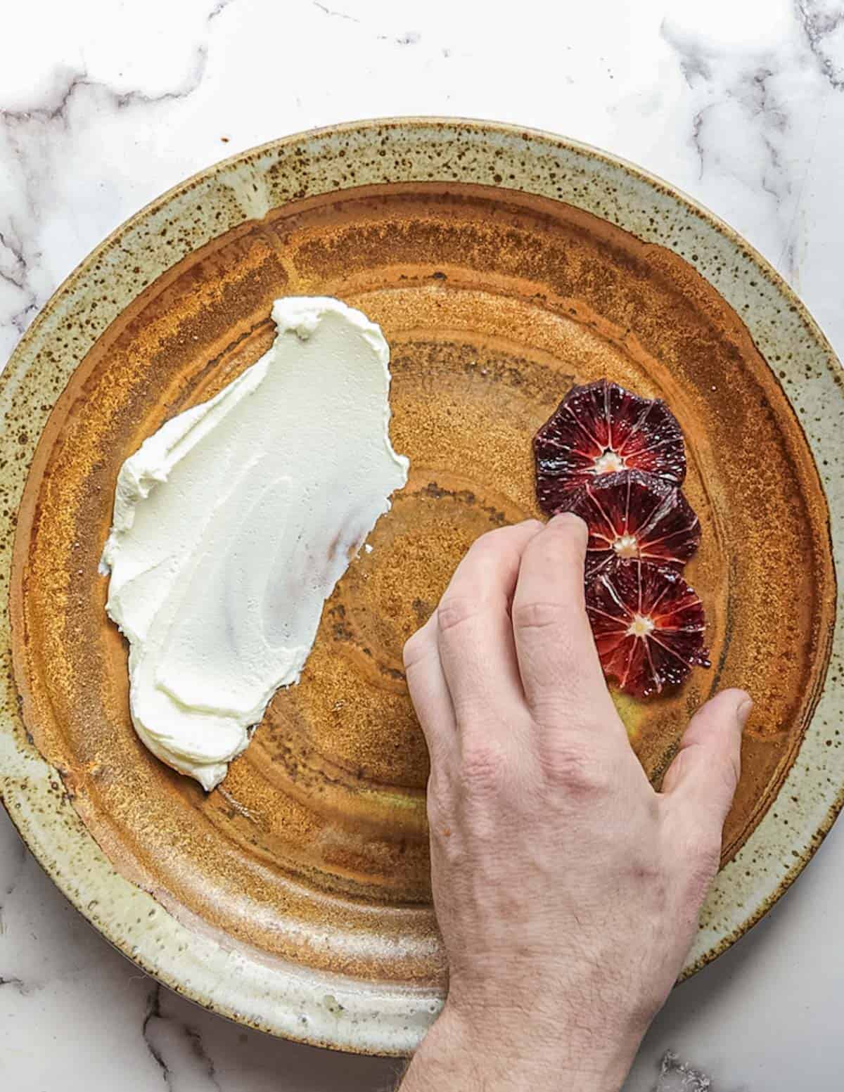 Arranging blood orange slices on a plate. 