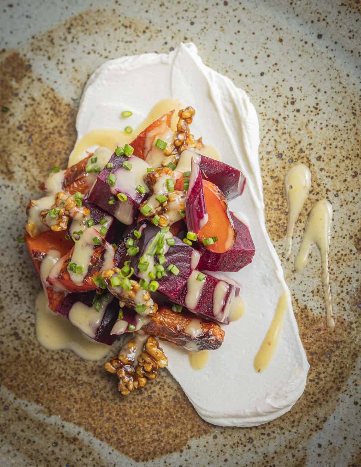 A salad of roasted beets and carrots with maple mustard dressing. 