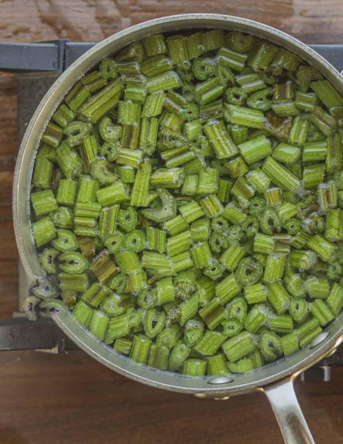 Boiling burdock leaf petioles in water. 