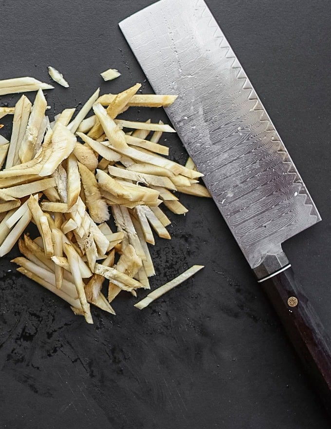 Thinly sliced julienned gobo root or burdock root. 
