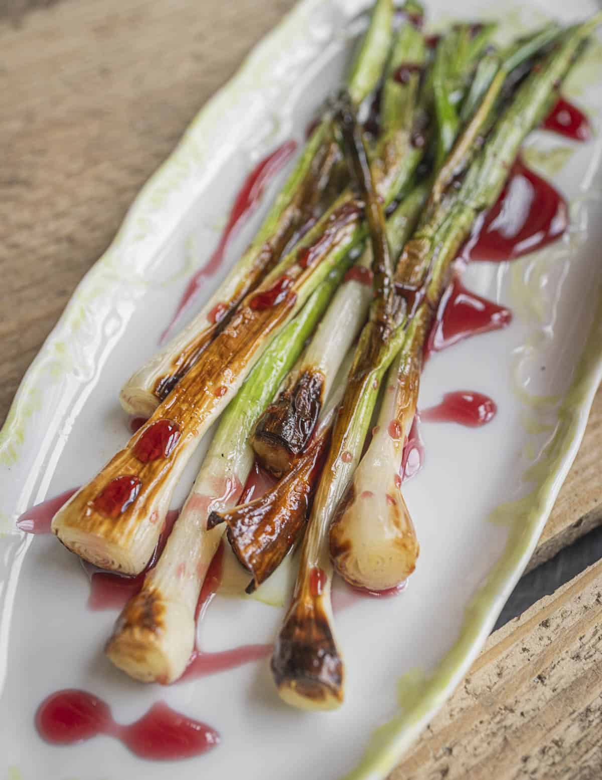 Grilled whole green garlic plants with chokecherry sauce. 
