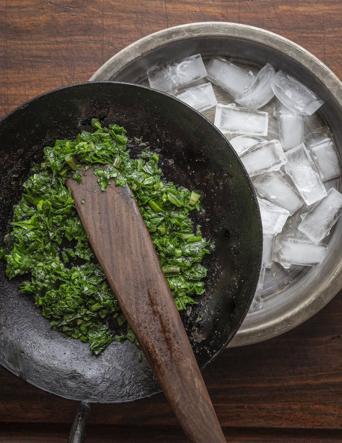 Cooking ramp leaves in a carbon steel skillet and chilling the pan over a pan of ice. 