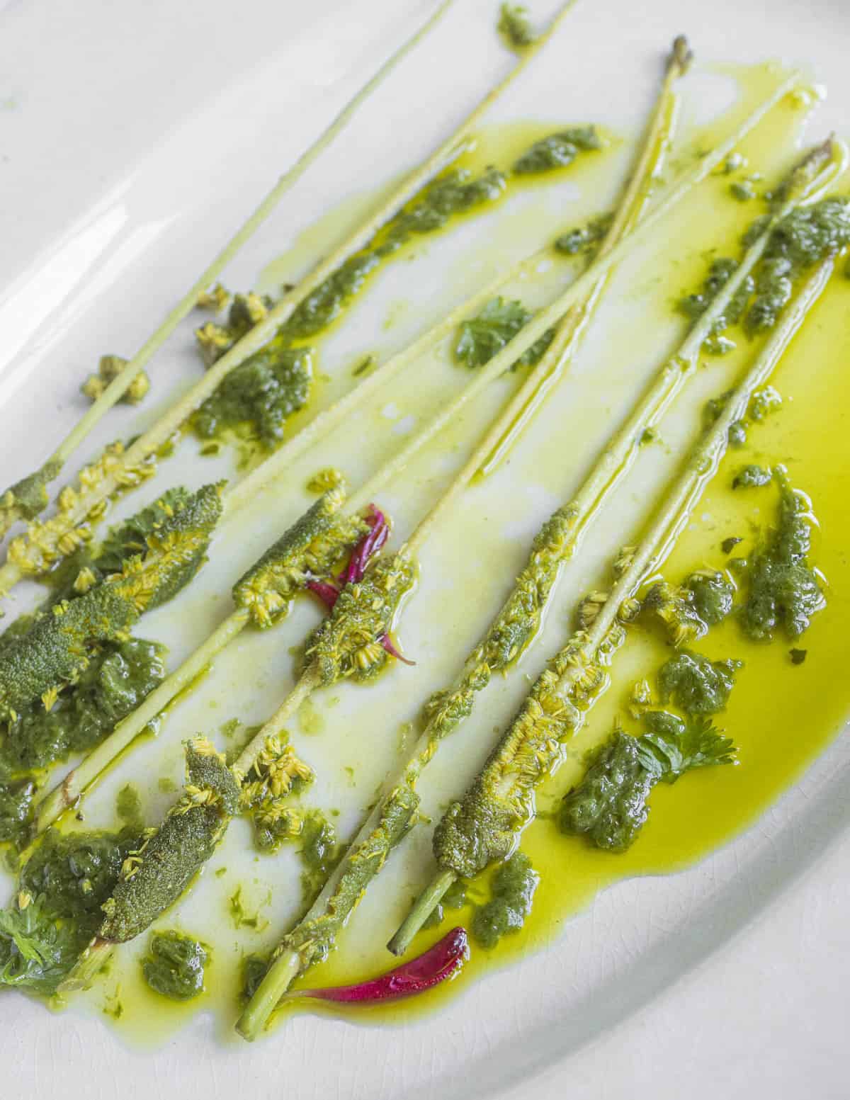 A plate of cooked cattail flower spikes after being eaten on a plate. 