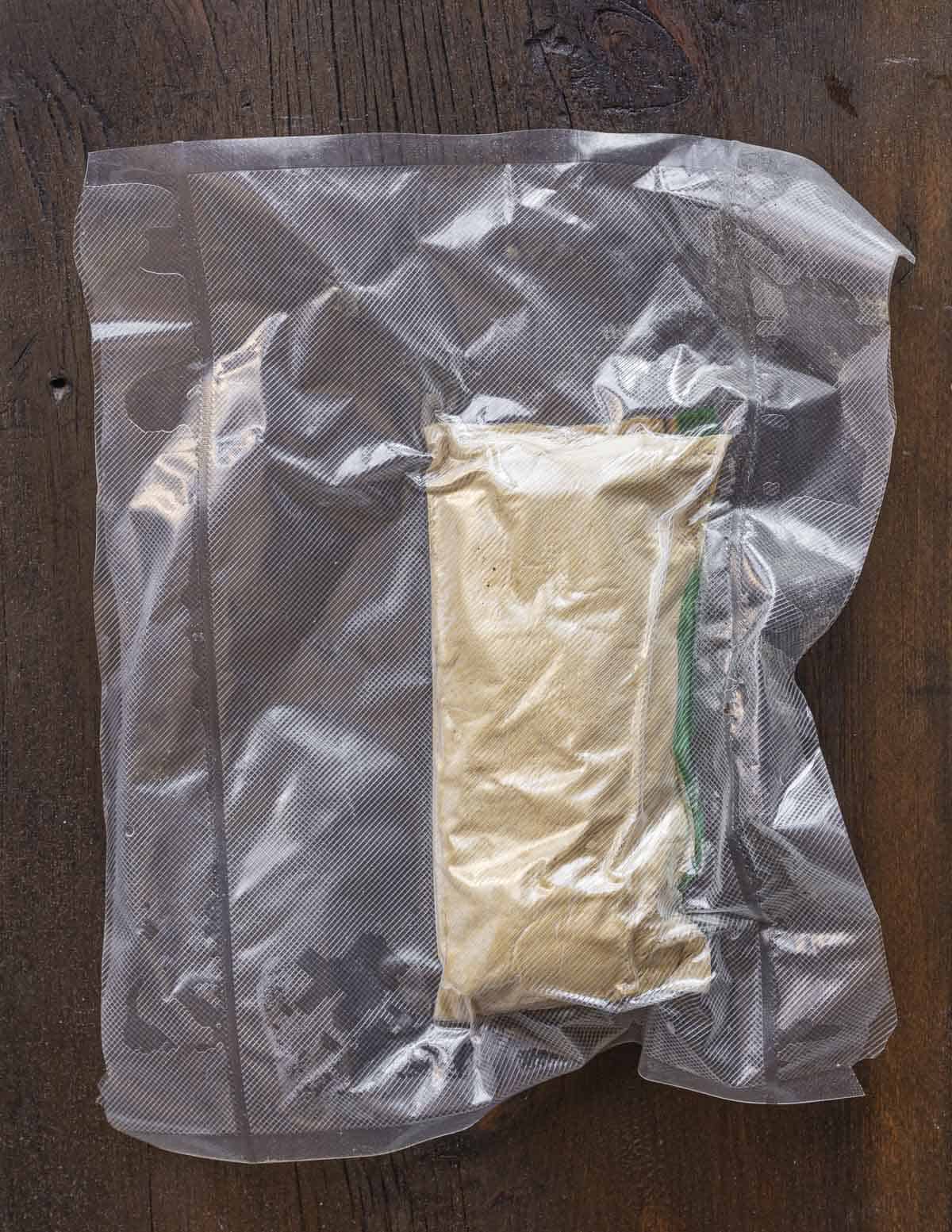 A bag of cattail pollen and sugar mixed together and vacuum sealed before cooking. 