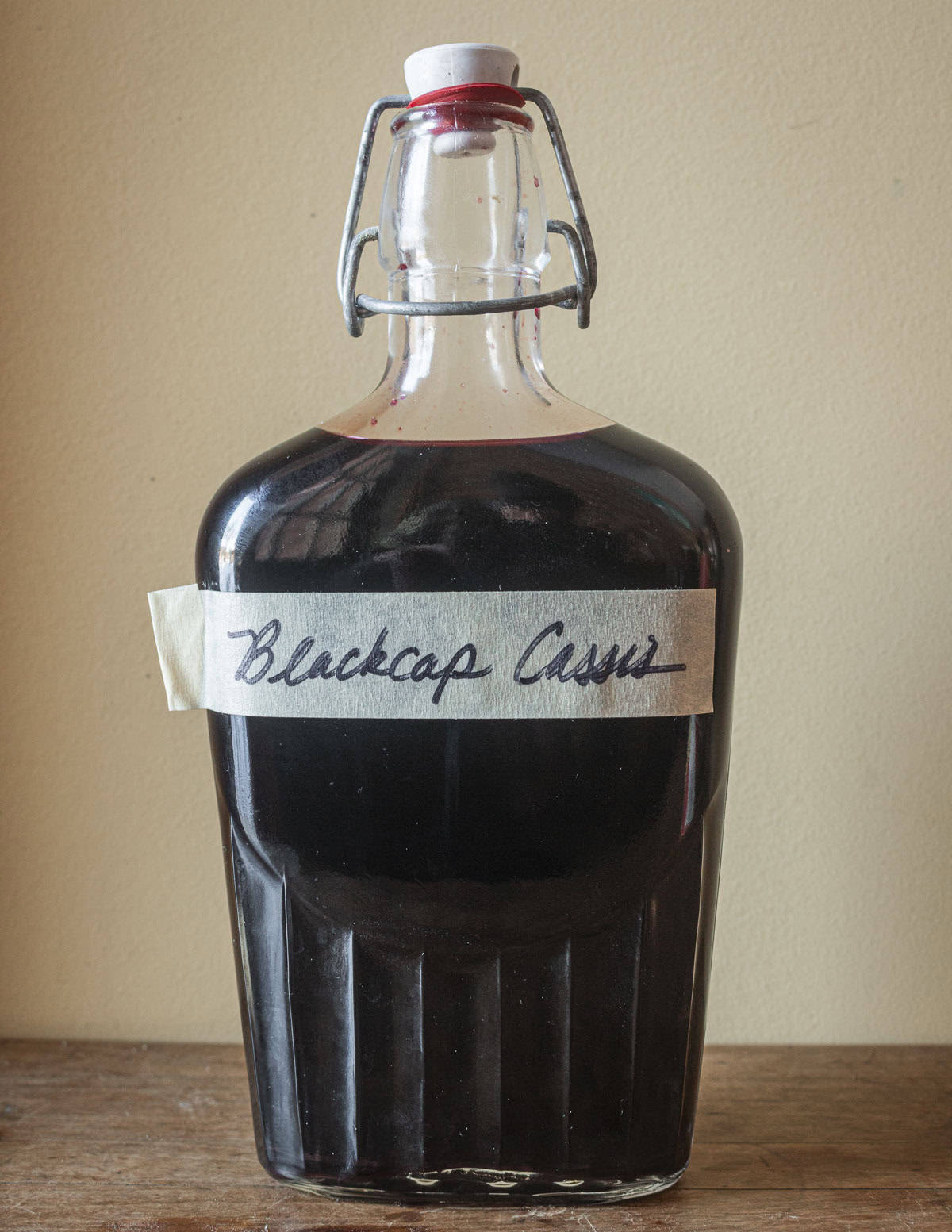 A bottle of raspberry liquor made with wild black raspberries. 