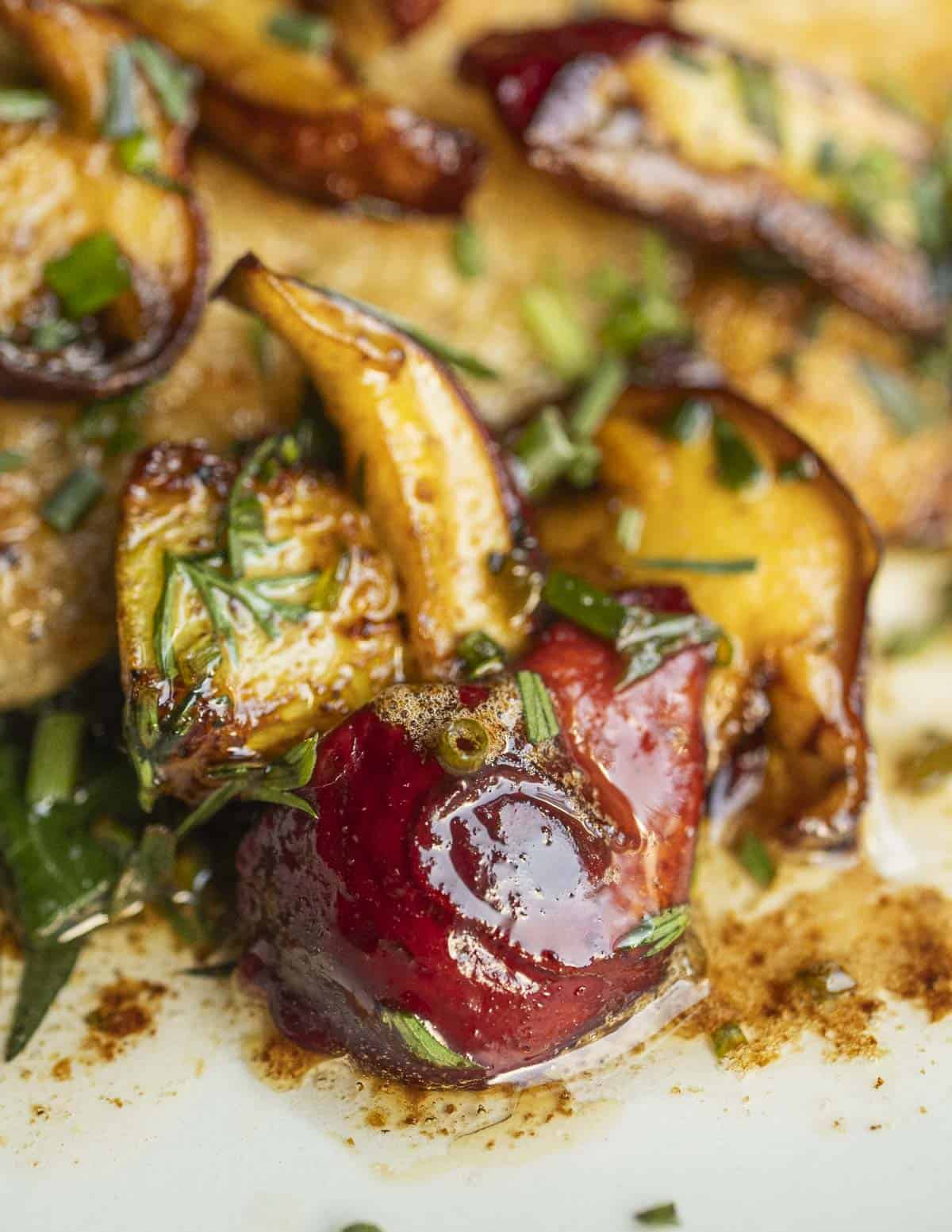 A close up image of cooked frost's bolete mushrooms in a lemon-butter sauce with herbs. 