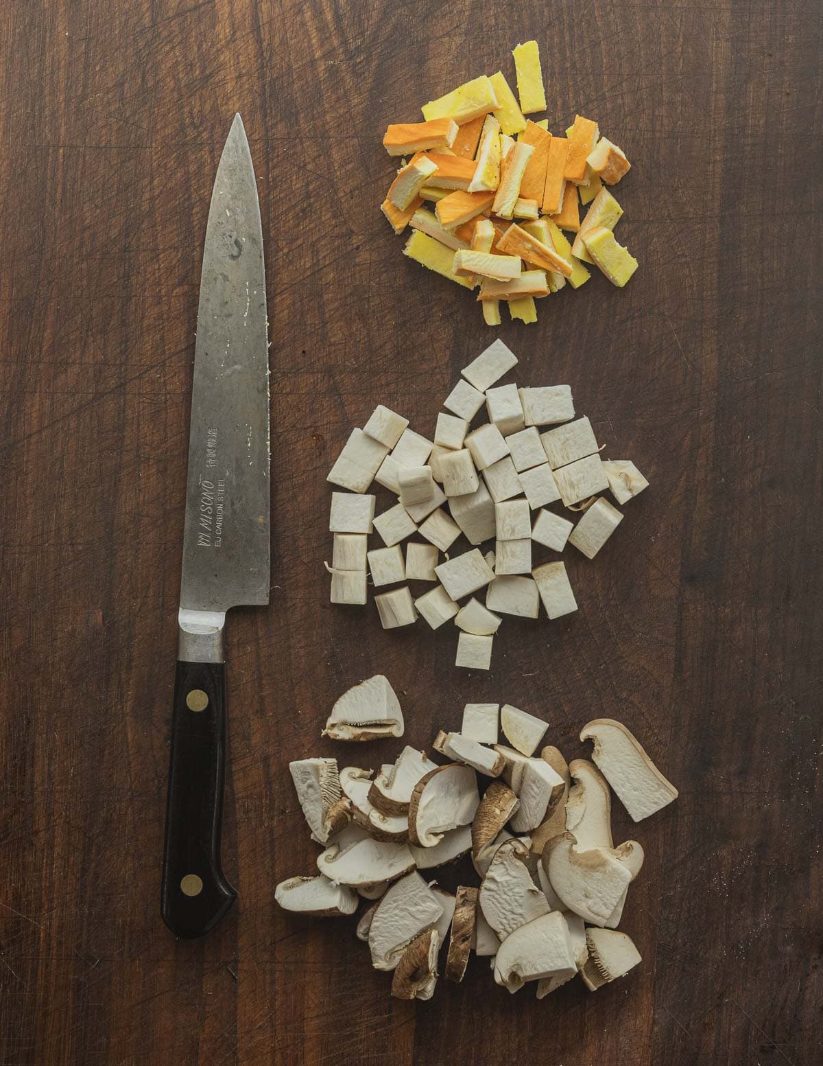 Cutting mushrooms into pieces that will fit on a tortilla chip with a utility knife. 