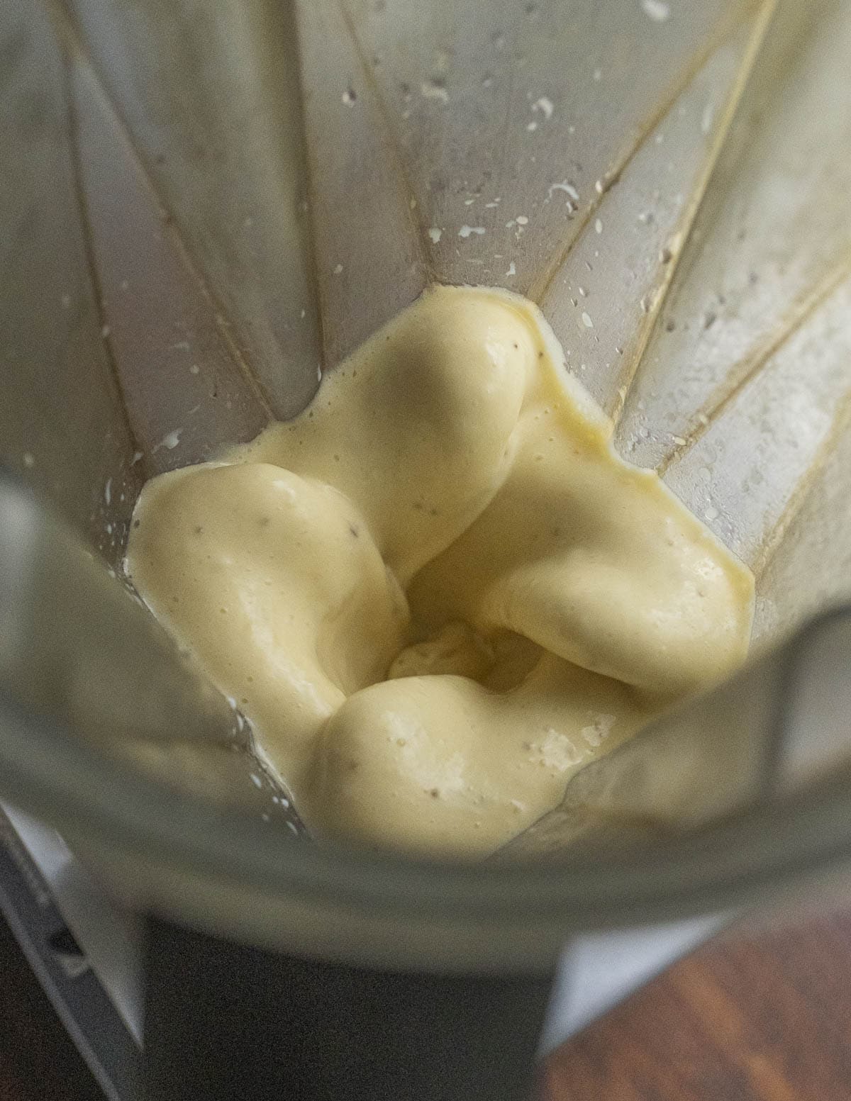 Pureeing eggs, bananas and milk in a blender until very smooth. 