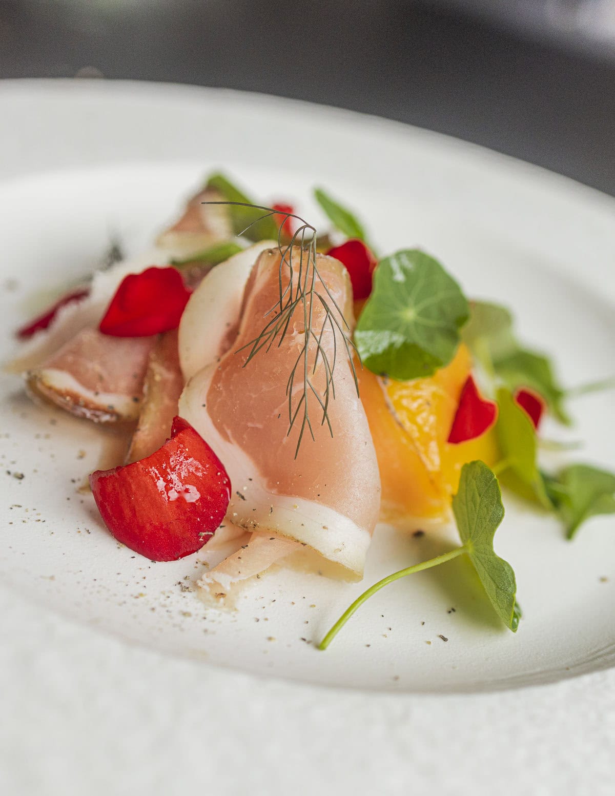 Paw paw salad with wild fennel seed cured ham, nasturtiums and begonia flowers. 