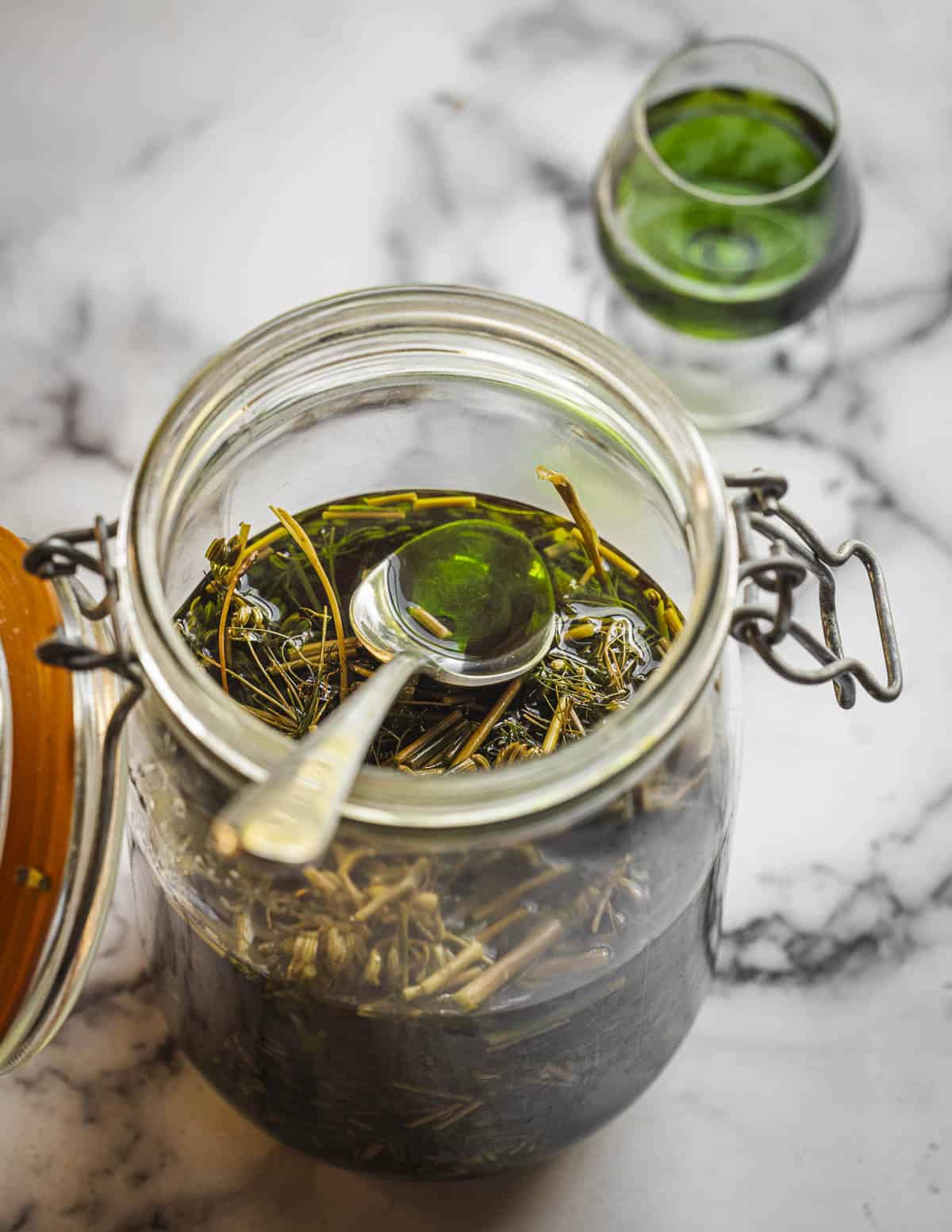 Italian fennel seed liquor in a jar showing a bright green hue. 