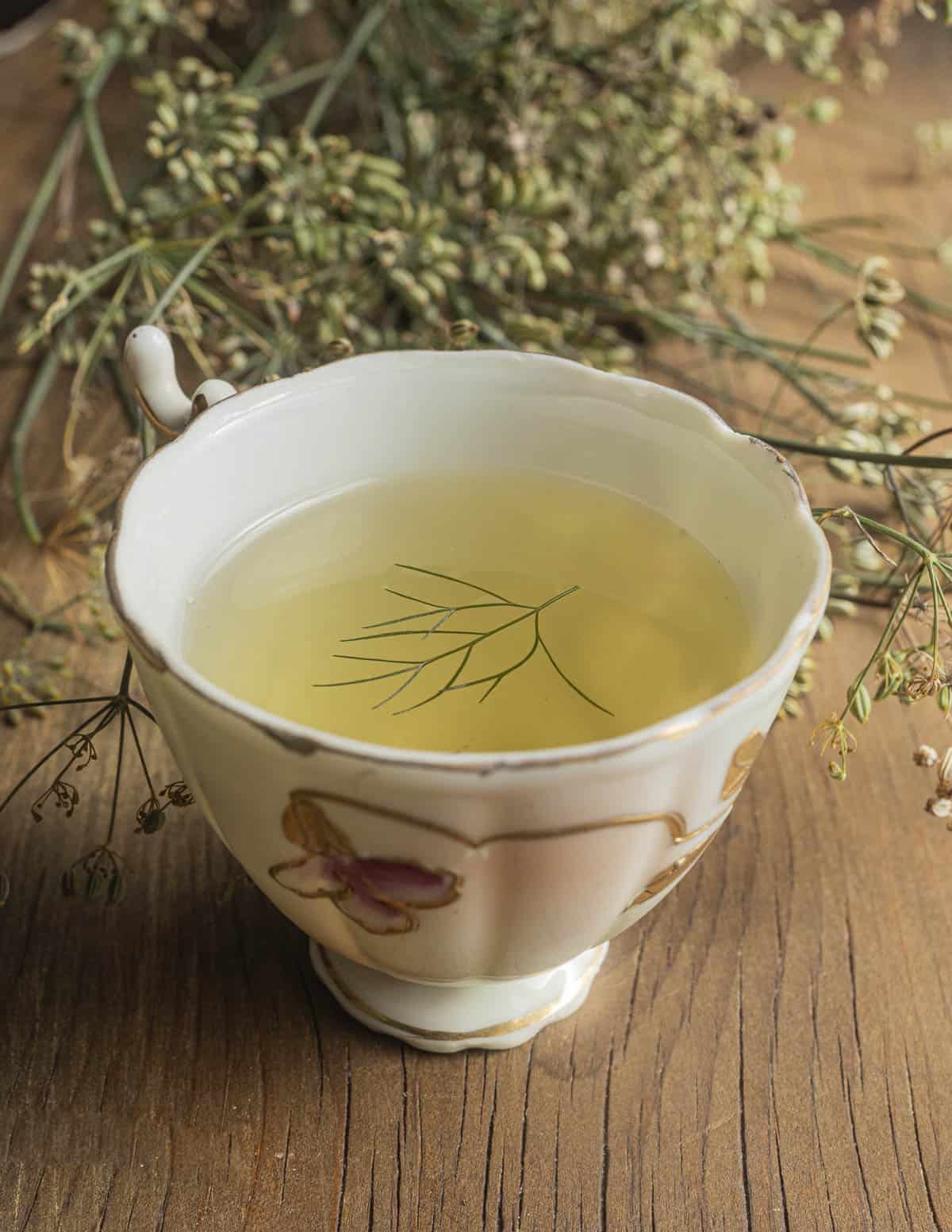 A small China cup filled with bronze fennel seed tea.