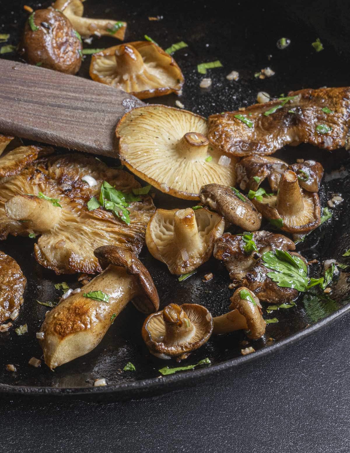 Finished pan of cooked fried chicken mushrooms with shallots and herbs. 