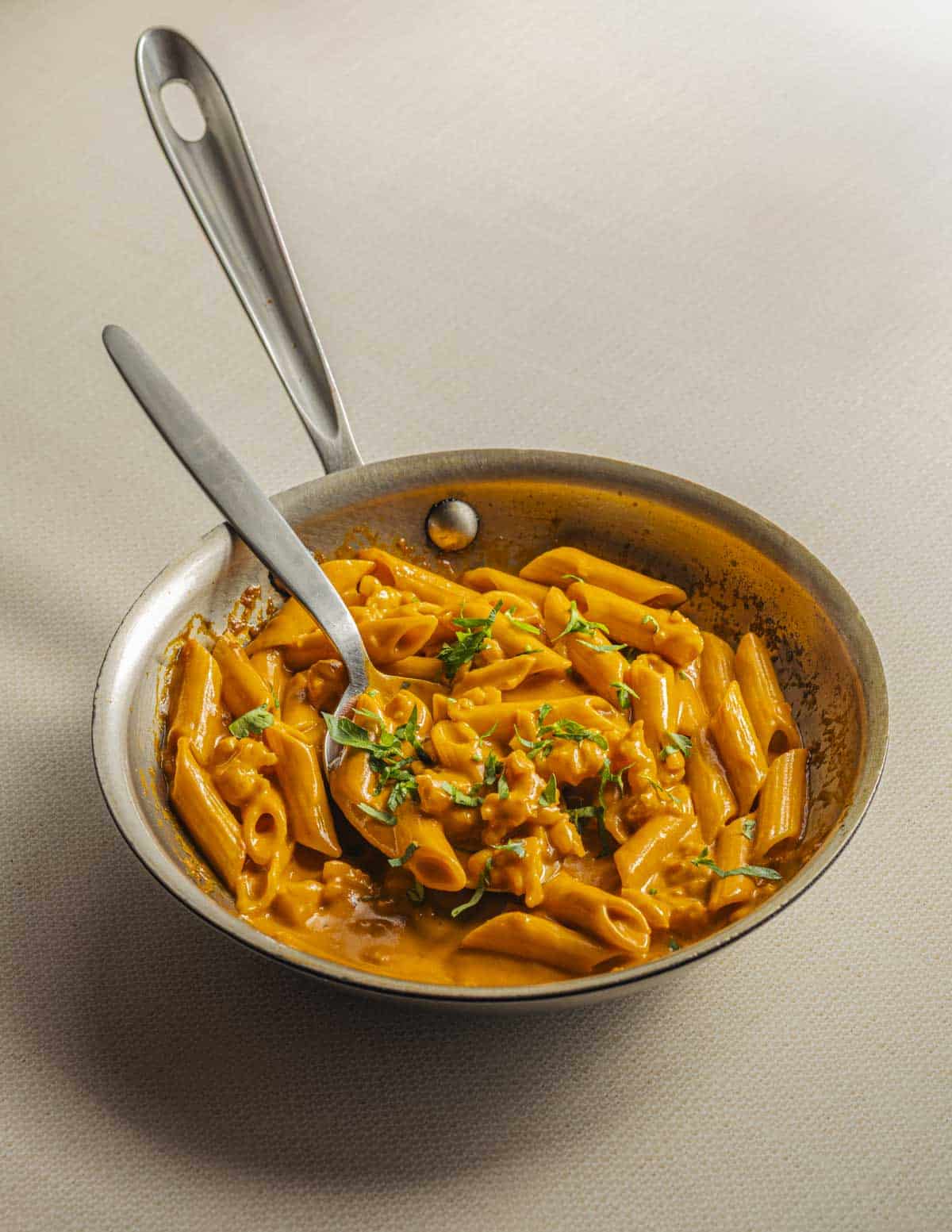 Penne with lobster sauce, shallots and parsley.