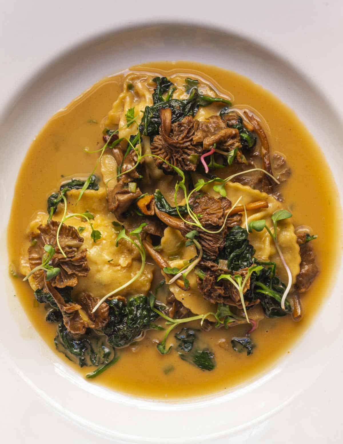 Swordfish ravioli with lobster butter sauce and yellowfoot chanterelles.