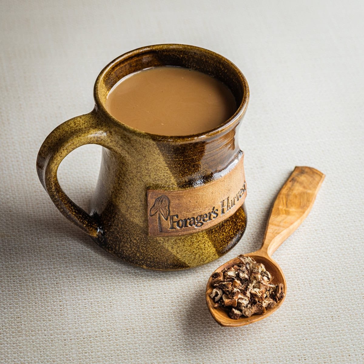 A finished mug of New Orleans chicory coffee served with milk in a mug.