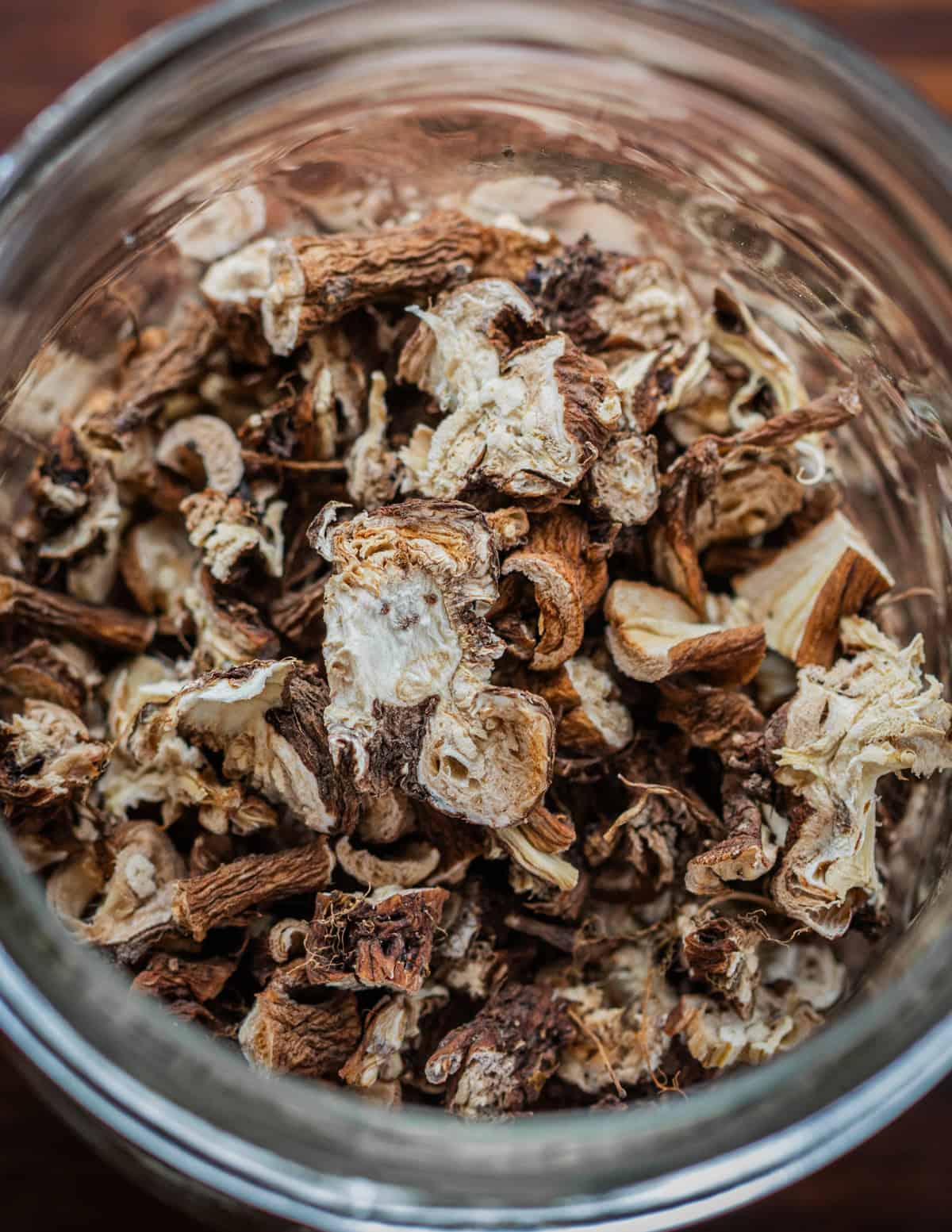 A jar of dandelion roots that have been dehydrated for storage.