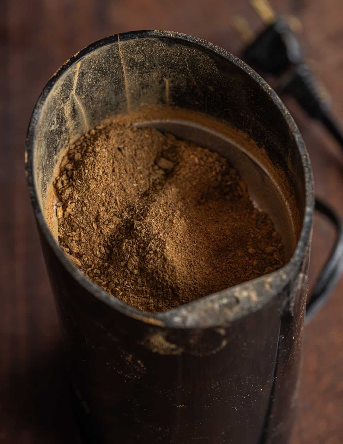 Powdered, ground, roasted dandelion roots in a spice grinder.