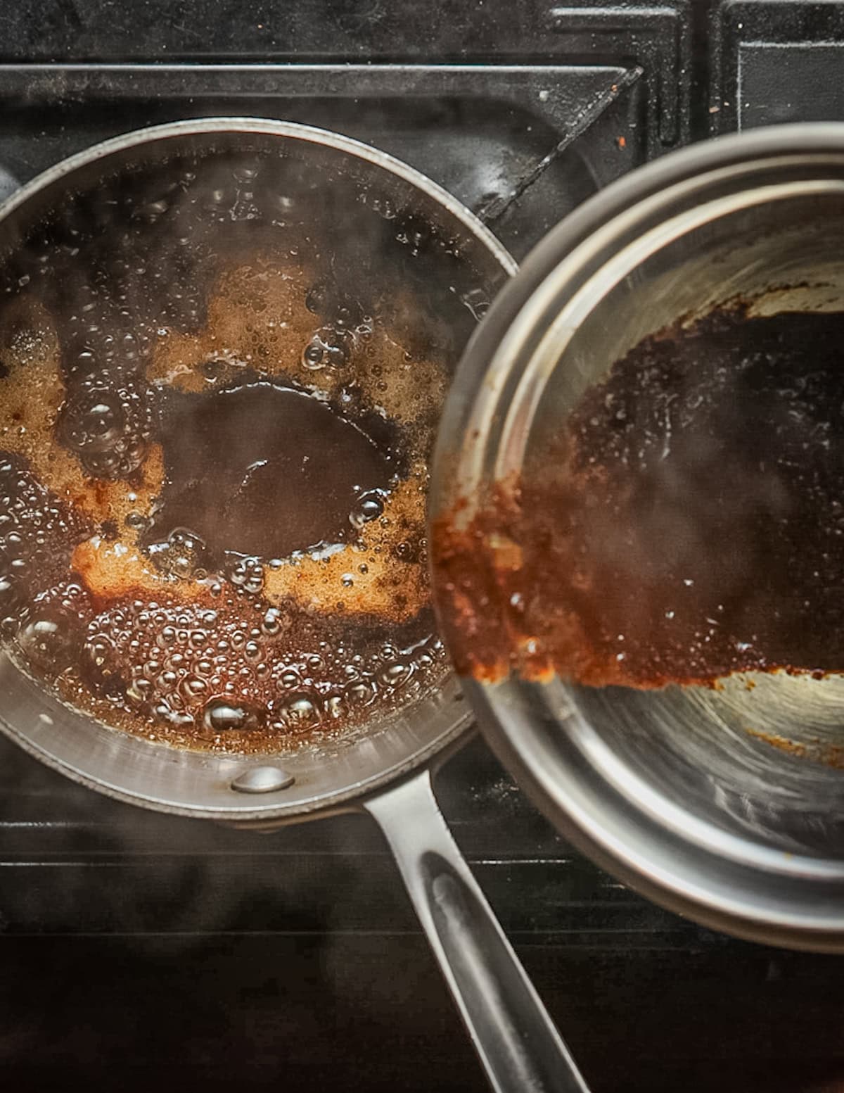 Adding dandelion coffee to a pot of boiled maple syrup.