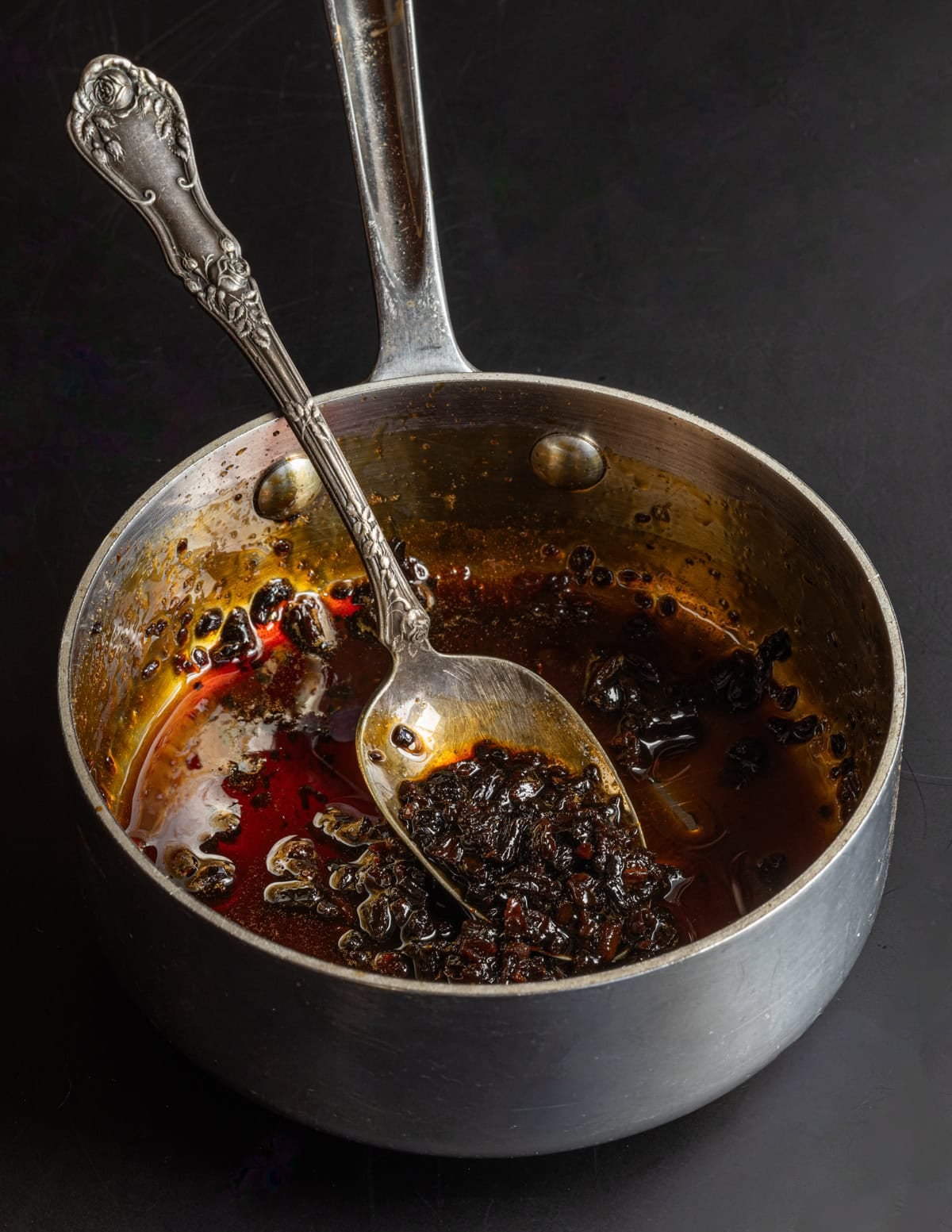 A pan of cooked dandelion roots simmered in maple syrup to make wild cocoa nibs.