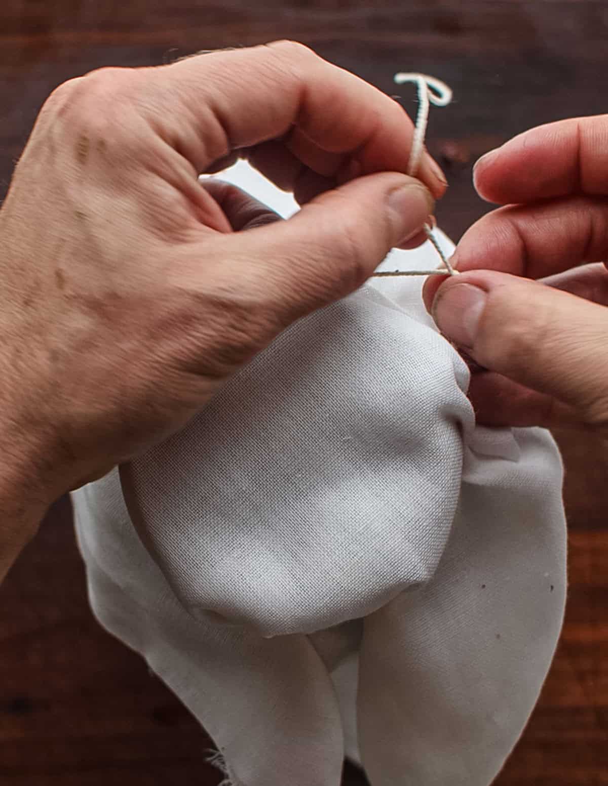 Covering a jar or homemade vinegar with cheesecloth to allow it to breathe while it ferments.
