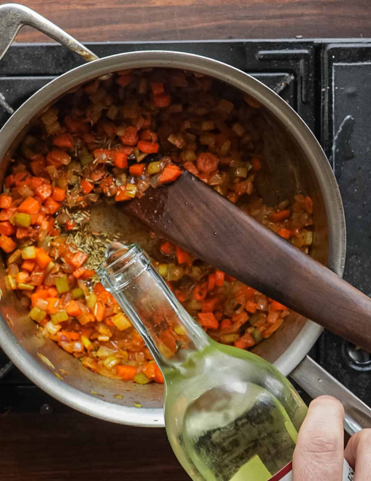 Deglazing a pan or vegetables with dry white wine.