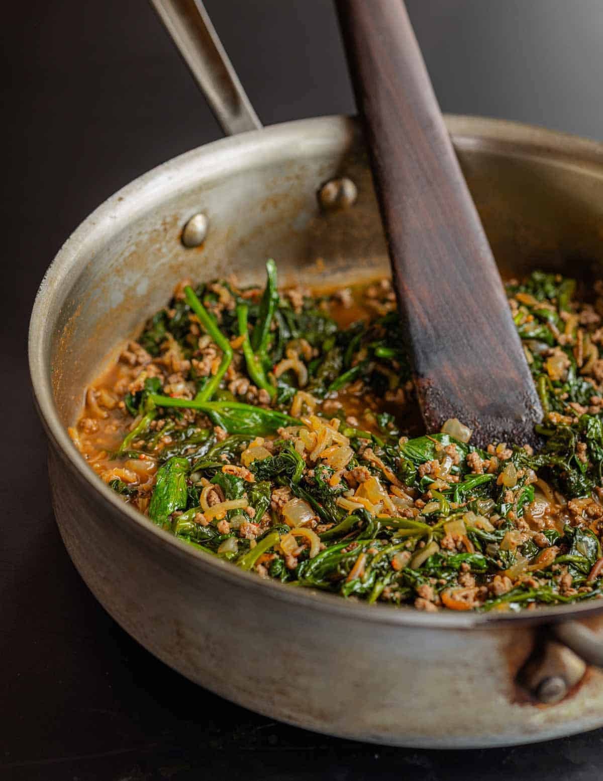 A pan of Kıymalı Ispanak Yemeği Turkish greens with rice and lamb.