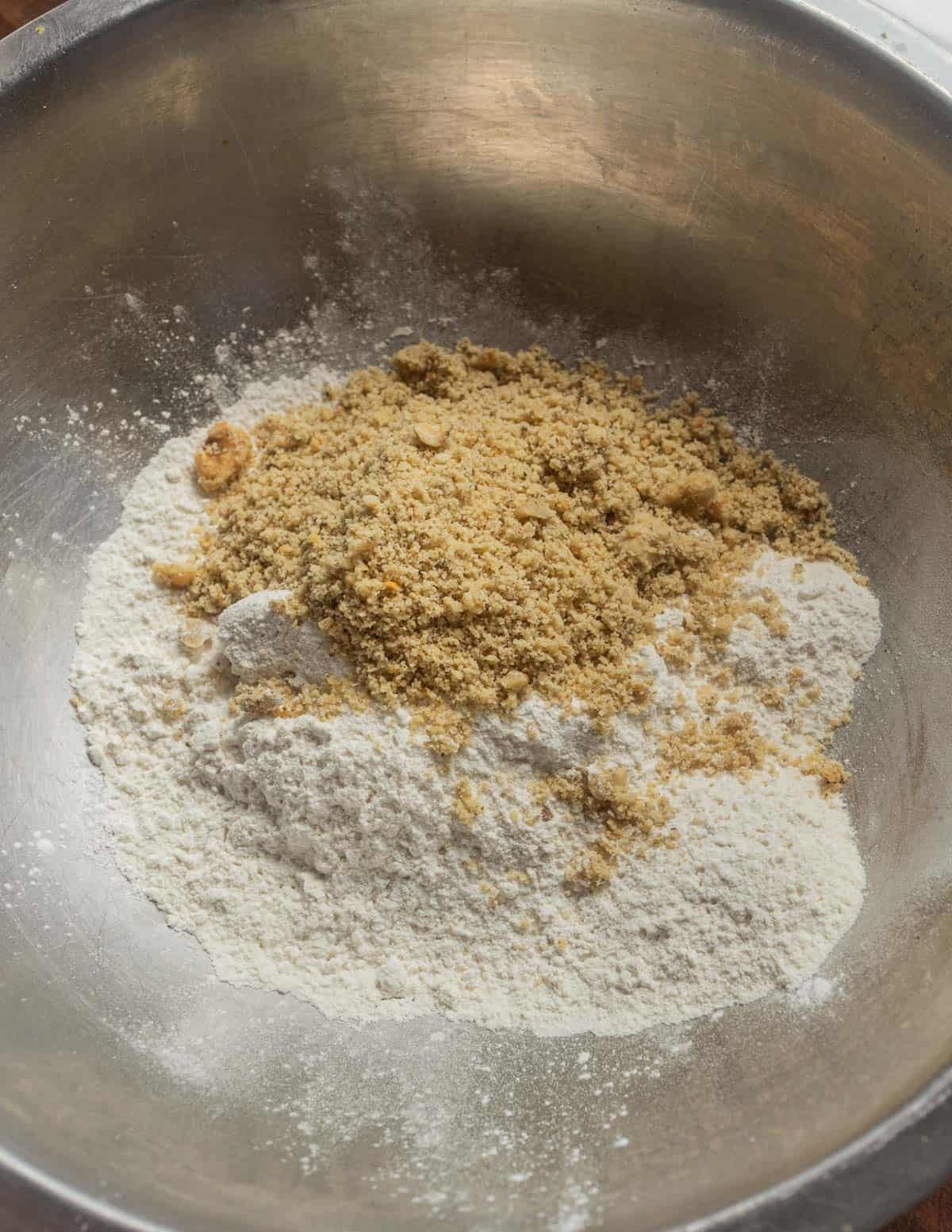 Mixing walnut flour into flour to make bar cookie crust.