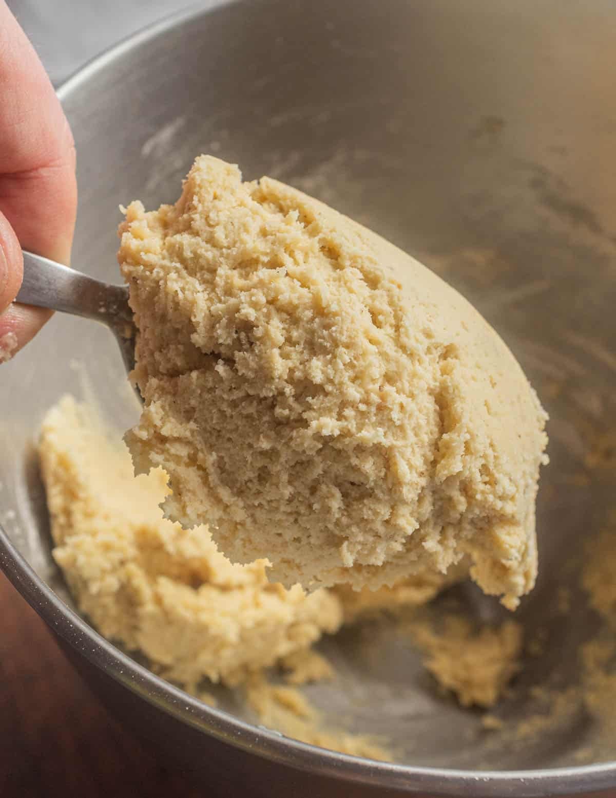 A spoon holding bar cookie dough showing it's evenly mixed.