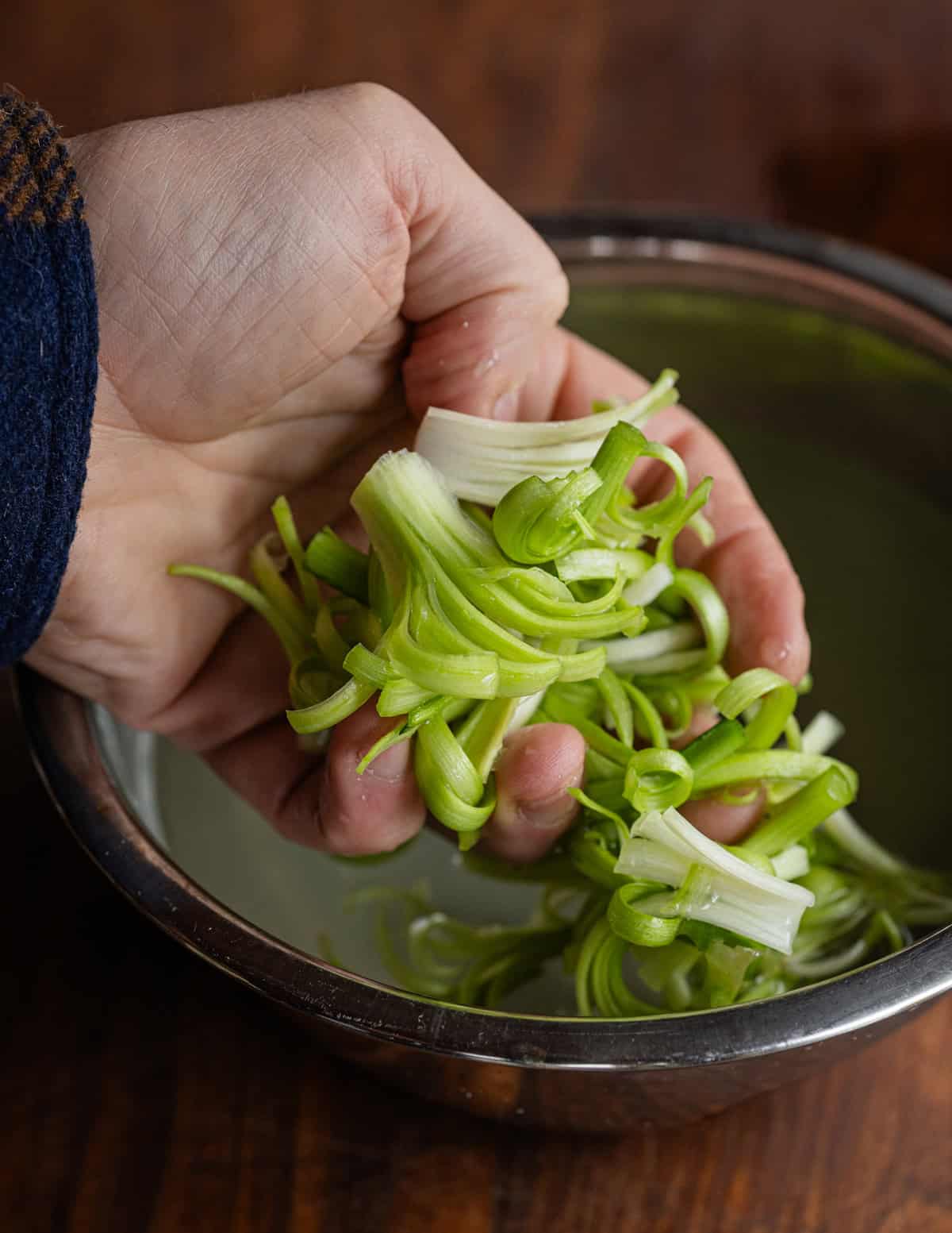 A handful of thinly sliced patience dock stems.