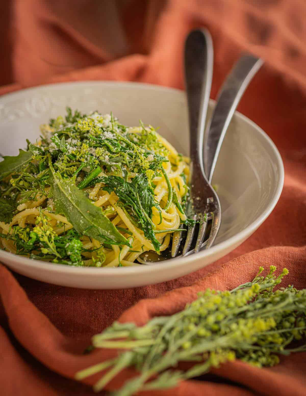 Spaghetti with peppergrass seeds, wild mustard greens, mustard seed pods and parmesan.