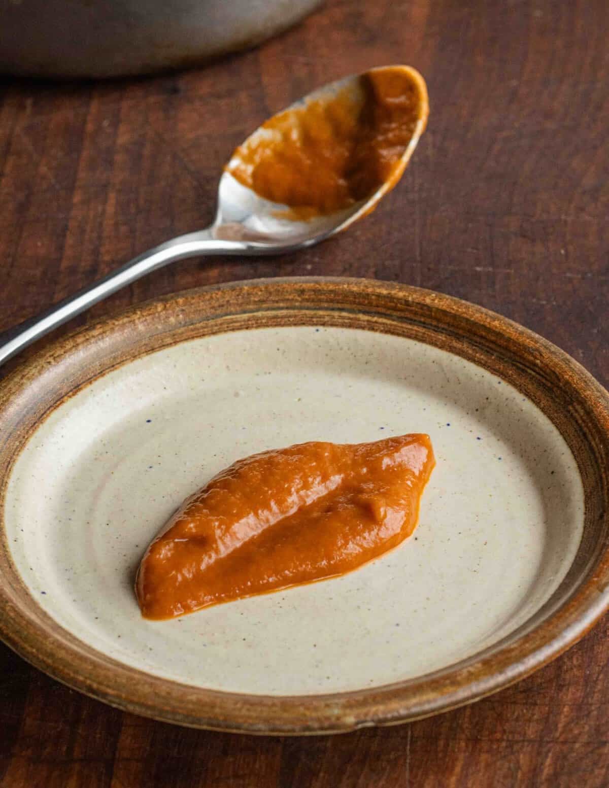 Smooth pureed rhubarb sauce on a plate.