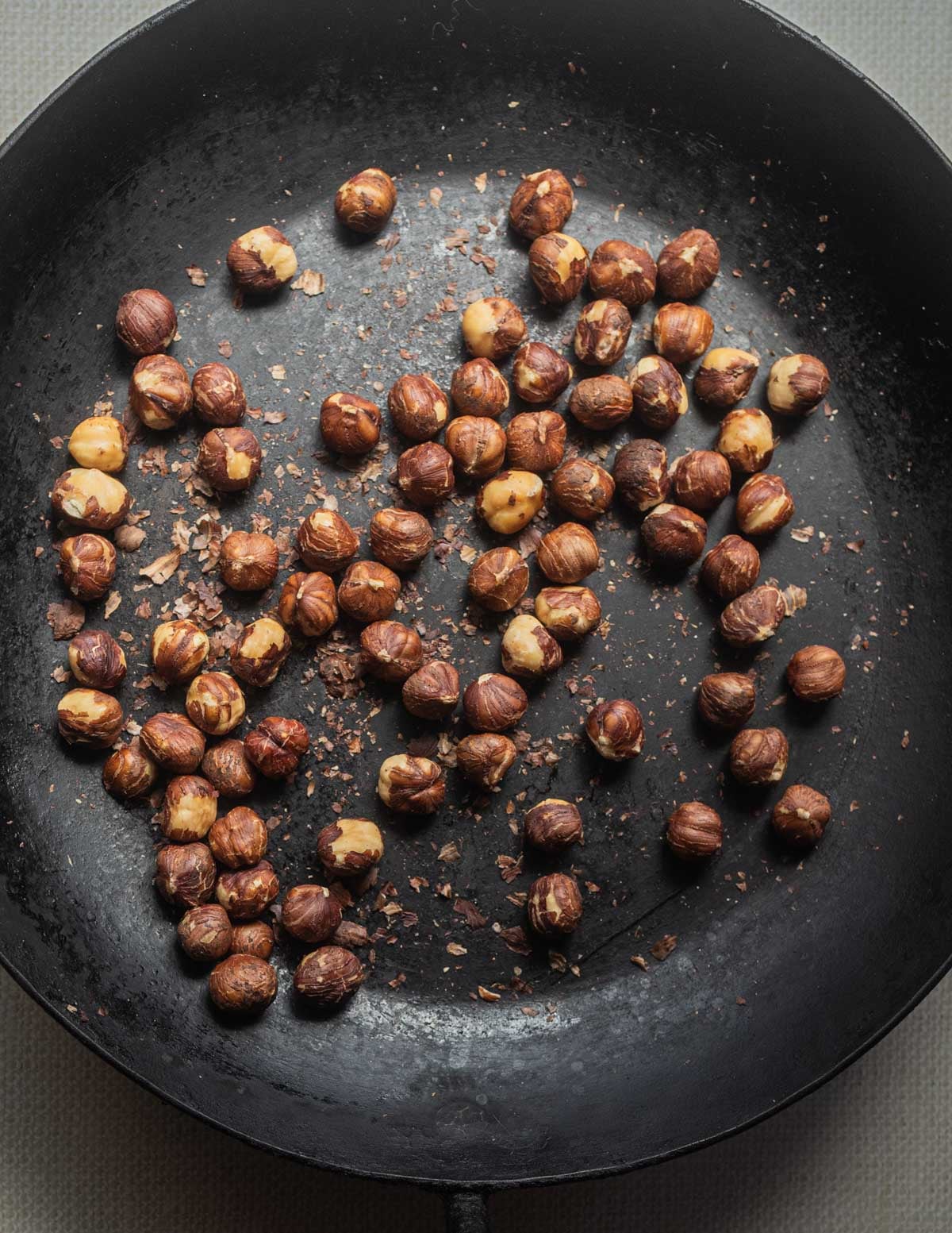 Toasting conventional hazelnuts in a Kehoe carbon steel pan.