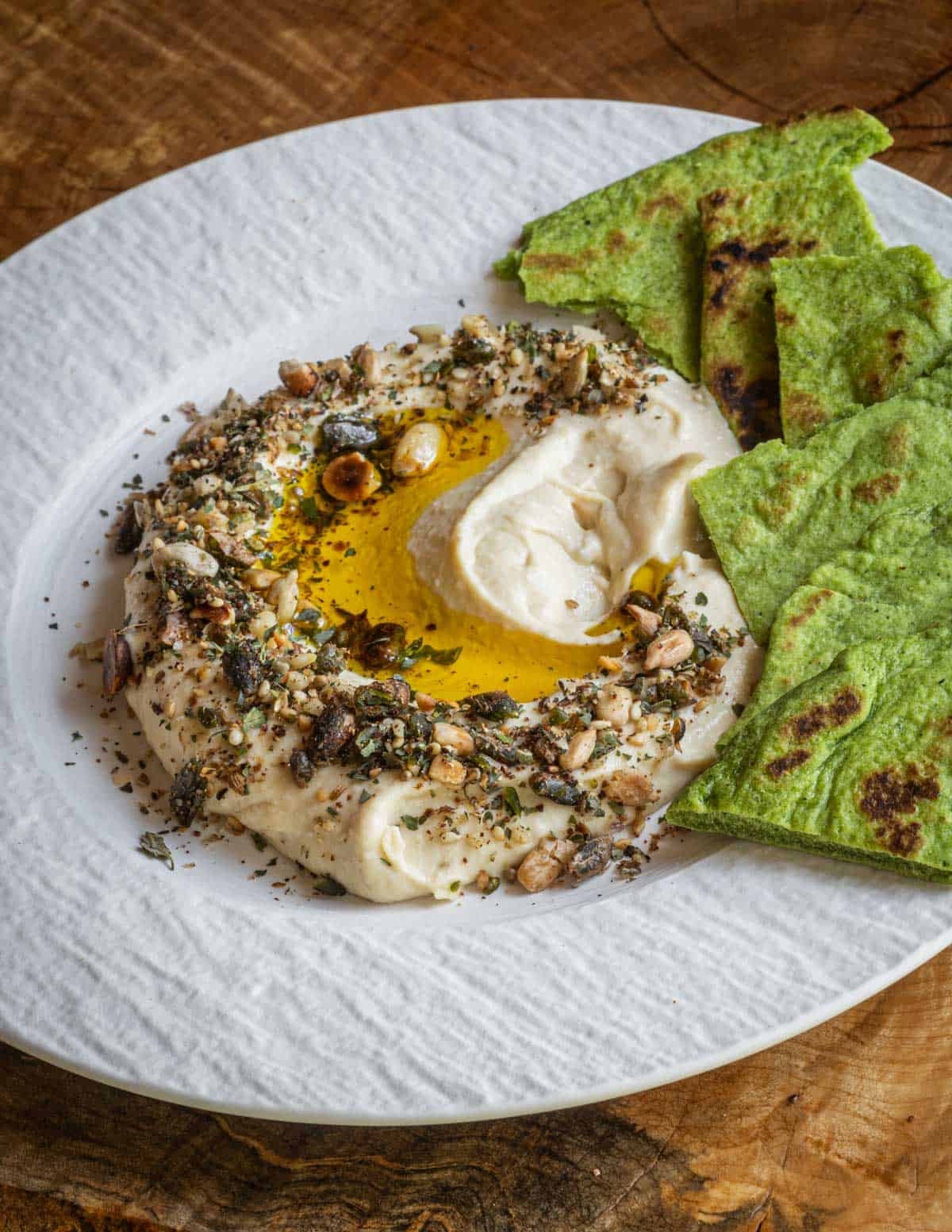 Hummus with wild nut and seed dukka spice, extra virgin rapeseed oil and ramp leaf flatbread.