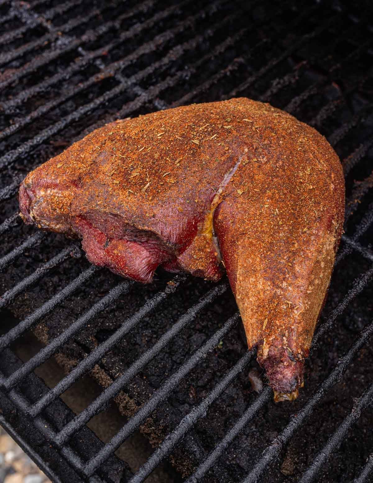A wild turkey leg on the smoker.