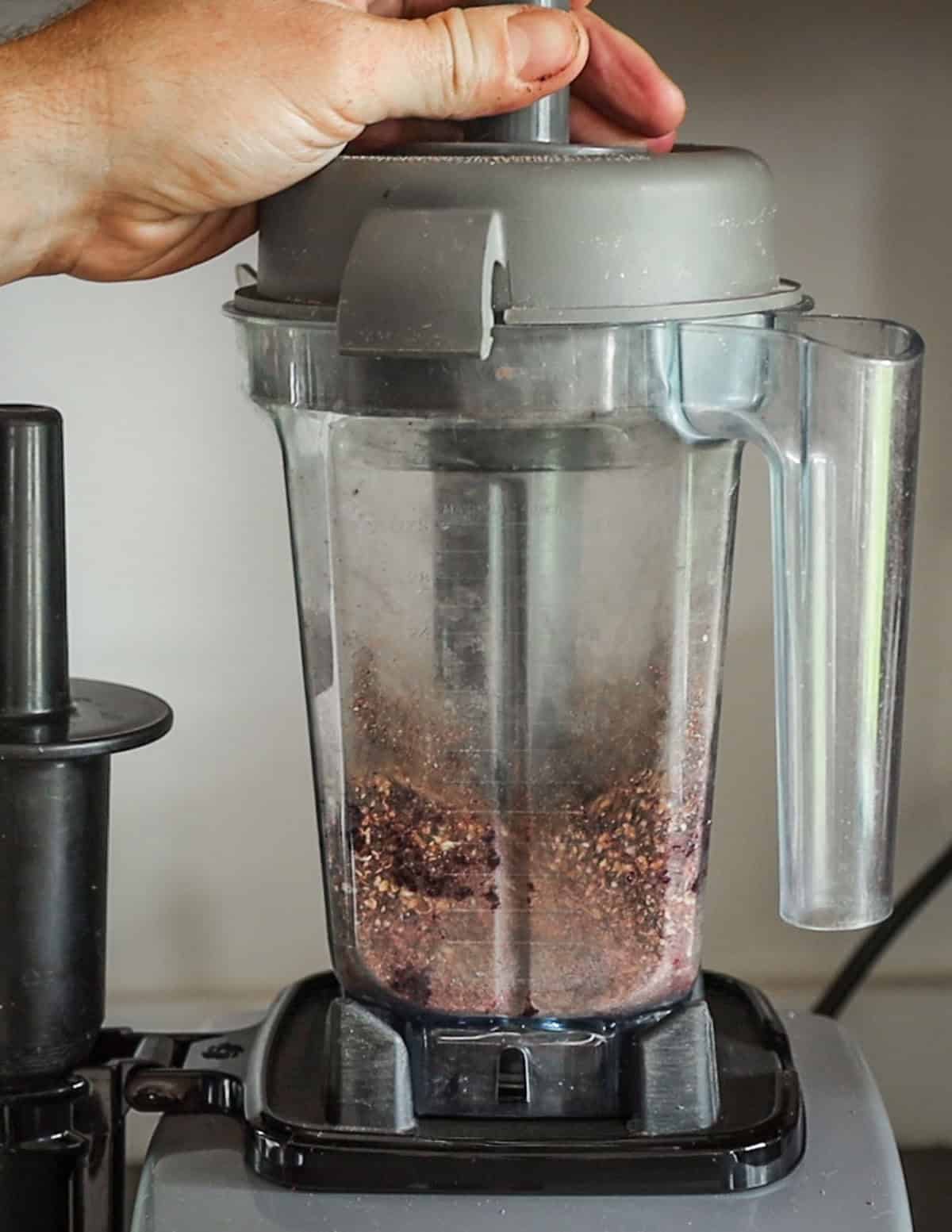 Grinding dried wild cherries to a flour for making pemmican.