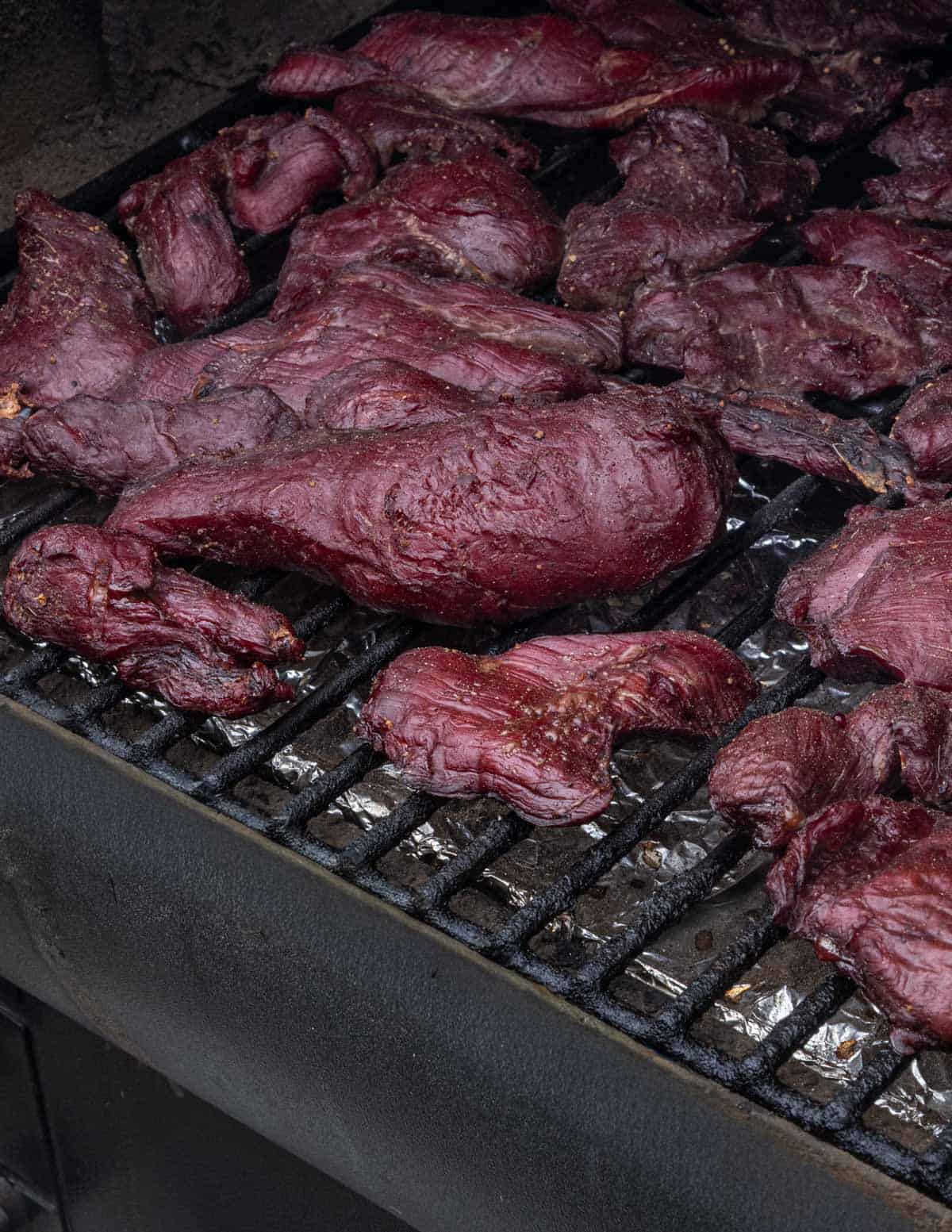 Strips of venison smoking in a pellet smoker before making pemmican.