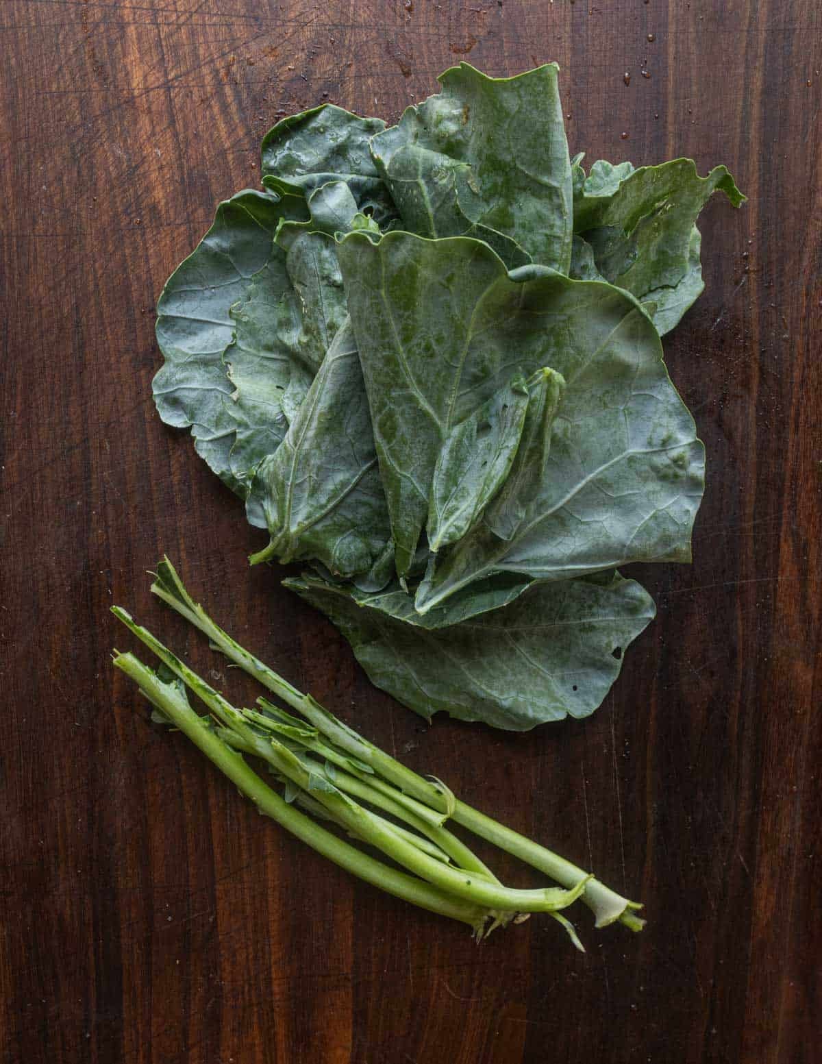 Removing the stems from kohlrabi greens before cooking.
