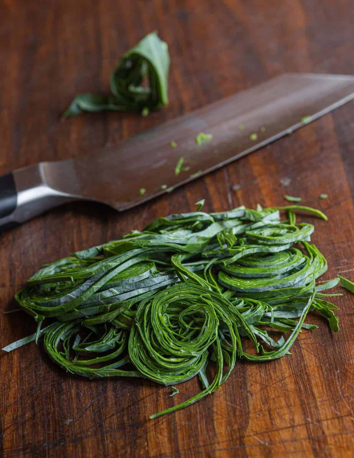 Rolled, thinly shaved kohlrabi greens cut very fine with a knife.