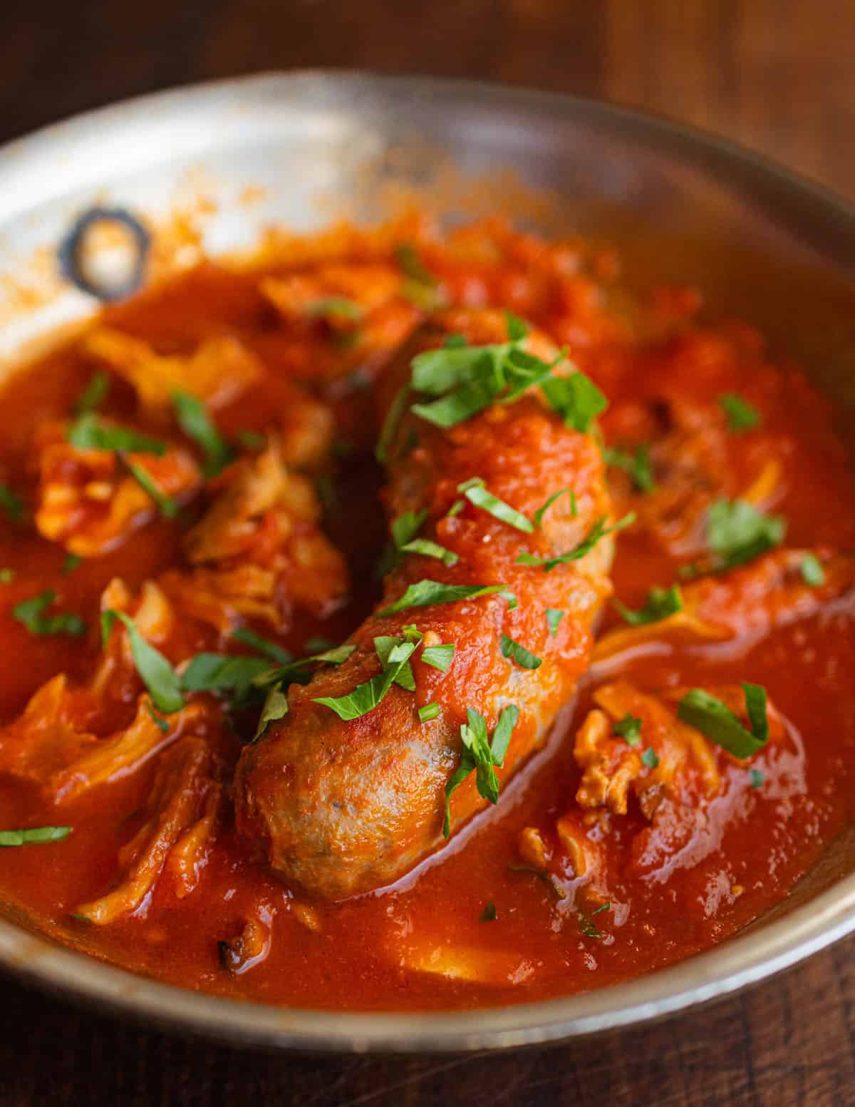 A slow braised Italian sausage garnished with sauteed mushrooms and chopped fresh parsley.