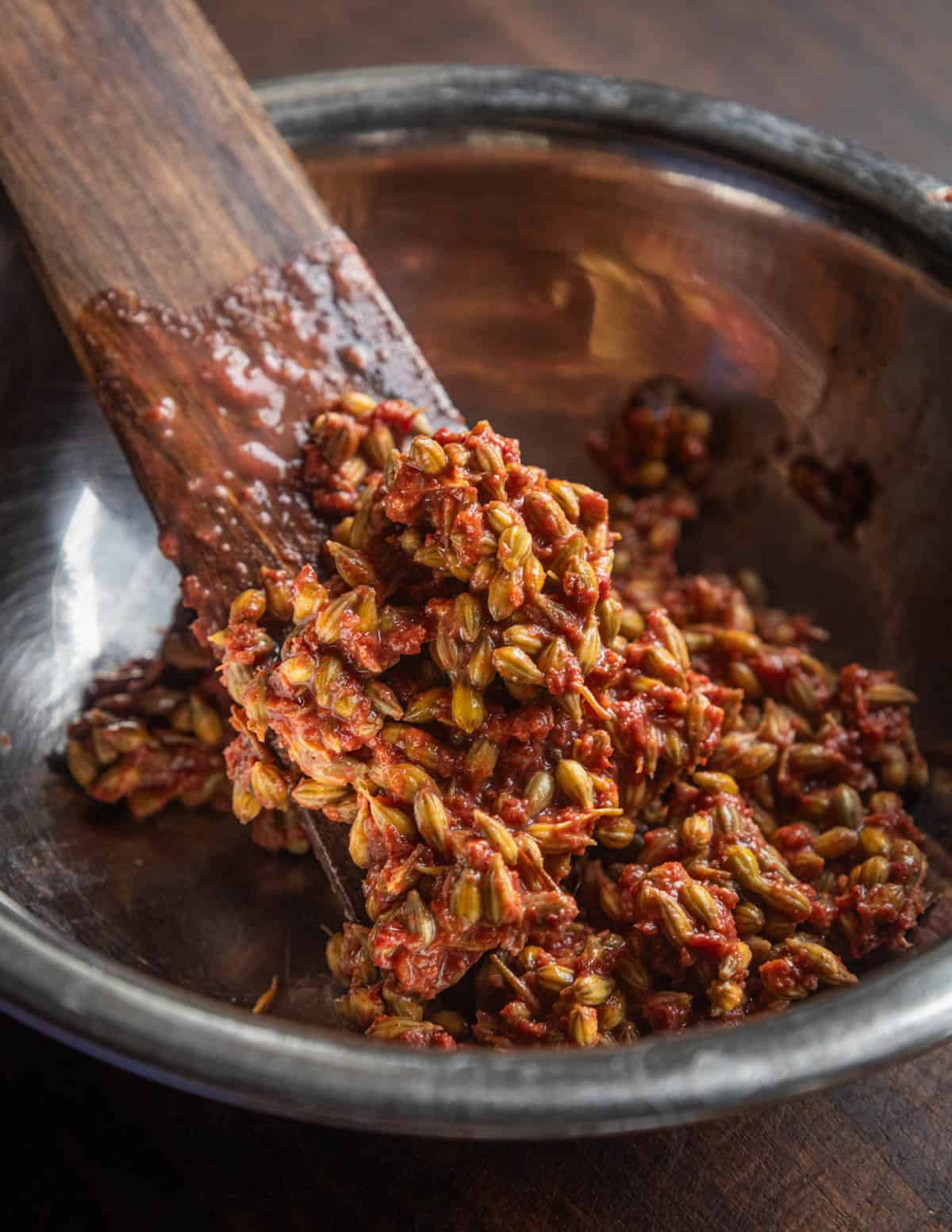 Autumn olive seeds and skin leftover in a bowl after straining to make juice.