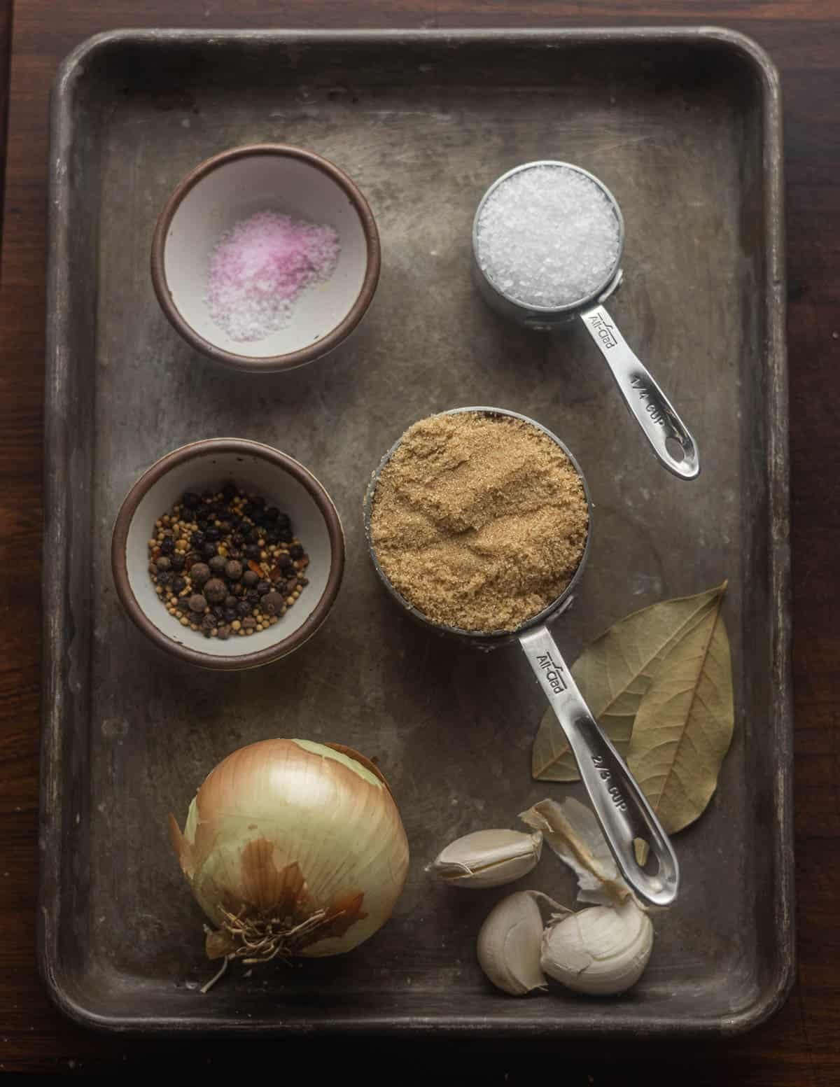 Goose pastrami bring ingredients: pink curing salt, kosher salt, brown sugar, pickling spices, bay leaf, garlic, onion.